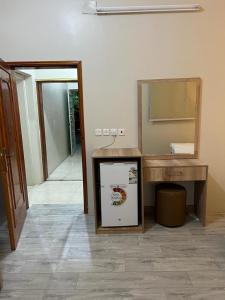 a room with a counter and a sink and a mirror at Albashier private apartment in AlUla