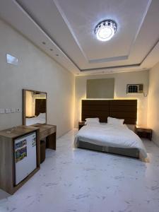 a large bedroom with a large bed and a sink at Albashier private apartment in AlUla