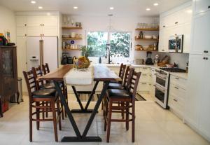 a kitchen with a wooden table and chairs at Casa Vitality Nosara in Nosara