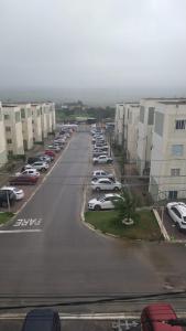 a parking lot with cars parked in front of buildings at Apto Charmoso Bosque Heliópolis in Garanhuns