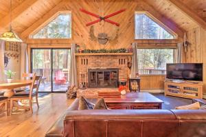 a living room with a couch and a fireplace at Alma Cloud 9 Cabin with Fireplace and Wooded Views! in Alma