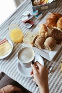 a table with a plate of bread and a cup of coffee at Destinar Apart in Carilo