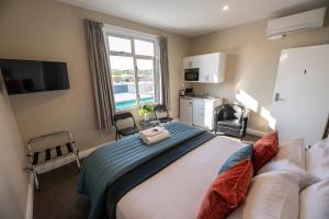 a bedroom with a large bed and a large window at The Amberley Hotel in Amberley