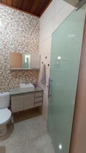 a bathroom with a toilet and a sink at Estalagem Alejandro in Cunha +23 photos