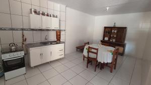 a kitchen with a table and a kitchen with a stove at Estalagem Alejandro in Cunha