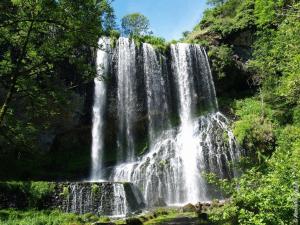 a waterfall in the middle of a forest at Gîte Le Vernet, 3 pièces, 4 personnes - FR-1-582-318 in Le Vernet