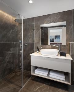 a bathroom with a sink and a shower at Amalon One Bedroom in Jerusalem