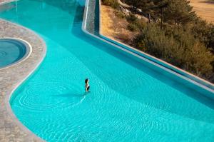 a person in the water in a swimming pool at Sono Felice Village Vivaldi Park in Hongcheon