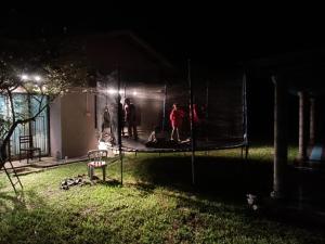 eine Gruppe von Menschen, die nachts auf einem Trampolin stehen in der Unterkunft ISLAMIC HOMESTAY @ KUALA ROMPIN , PAHANG . in Kuala Rompin