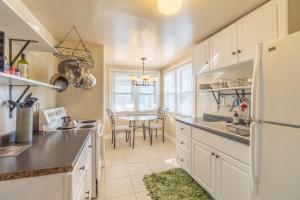 a kitchen with a table and a white refrigerator at Rustic 2-Bedroom walking distance to Downtown in Reno