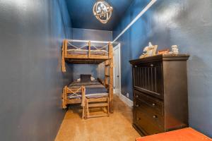 a bedroom with two bunk beds and a dresser at Rustic 2-Bedroom walking distance to Downtown in Reno