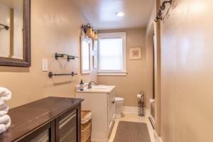 a bathroom with a sink and a toilet and a window at Rustic 2-Bedroom walking distance to Downtown in Reno
