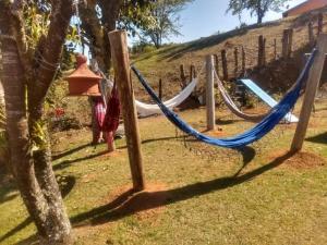 a playground with a hammock and a fire hydrant at Cantinho da Serra in Santo Antônio do Pinhal