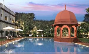 a swimming pool with a gazebo next to a building at The Grand Imperial - Heritage Hotel in Agra