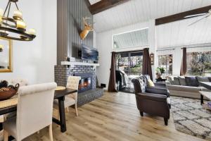 a living room with a fireplace and a table and chairs at Switzerland Slopes #2125 by Big Bear Vacations in Big Bear Lake