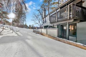 a snow covered street in front of a building at Switzerland Slopes #2125 by Big Bear Vacations in Big Bear Lake