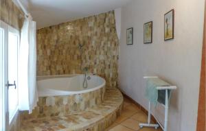 a bathroom with a bath tub in a room at 6 Bedroom Amazing Home In Entrecasteaux in Entrecasteaux