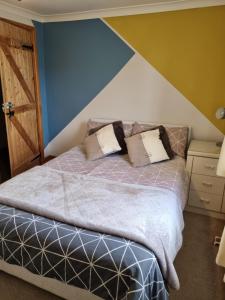 a bed with two pillows on it in a bedroom at Mallard Cottage Guest House in Aylesford