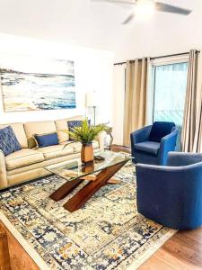 a living room with a couch and two chairs at The Bromeliad at Turtle Cove Villas in Kiawah Island