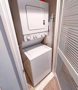 a washer and dryer with a microwave on top of it at The Bromeliad at Turtle Cove Villas in Kiawah Island