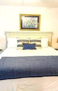 a bedroom with a large bed with a blue blanket at The Bromeliad at Turtle Cove Villas in Kiawah Island