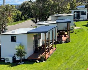 a small house with an awning on the grass at Marlo Caravan Park & Motel in Marlo