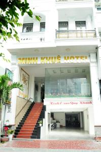 a white building with a minnie kine hotel at Minh Khue Hotel in Quy Nhon