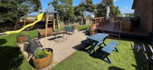 a playground with a picnic table and a slide at Marlo Caravan Park & Motel in Marlo