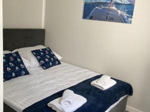 a bedroom with a bed with towels on it at Holiday house with swimming pool for 7 people in Swinoujscie in Świnoujście