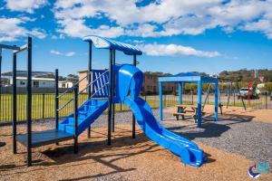 a playground with a blue slide in a park at Apollo Unit 14 1st Floor in Narooma