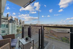 a balcony with a view of a city at Exclusive Stays - Gallery Tower in Melbourne