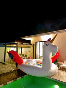 a inflatable unicorn boat sitting on top of a pool at One season poolvilla in Bang Sare