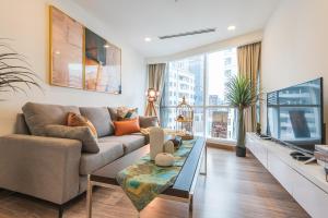 a living room with a couch and a tv at 2BR Tourists-Friendly Oasis - Heart of the City KL by Verano in Kuala Lumpur