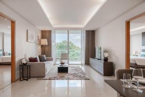 a living room with a couch and a tv at North Park Serviced Apartment Bangkok in Bangkok
