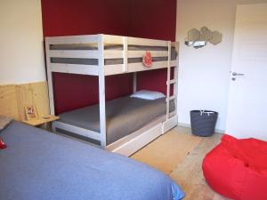- une chambre avec 2 lits superposés et un mur rouge dans l'établissement Appartement Villard-de-Lans, 3 pièces, 6 personnes - FR-1-689-14, à Villard-de-Lans