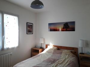a bedroom with a bed and a picture on the wall at Appartement Villard-de-Lans, 4 pièces, 8 personnes - FR-1-689-9 in Villard-de-Lans