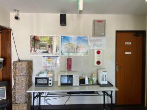 a table with two microwaves on it in a room at Southern Village Okinawa in Kitanakagusuku