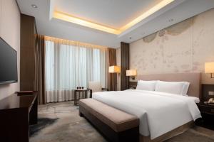 Postel nebo postele na pokoji v ubytování Yun Hotel Wuhan + 28 fotografií