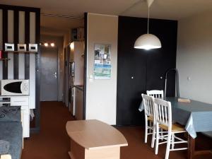 a kitchen and dining room with a table and chairs at Studio Villard-de-Lans, 1 pièce, 4 personnes - FR-1-689-46 in Villard-de-Lans