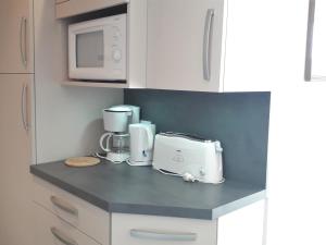 a kitchen counter with a coffee maker and a microwave at Appartement Villard-de-Lans, 2 pièces, 5 personnes - FR-1-689-65 in Villard-de-Lans