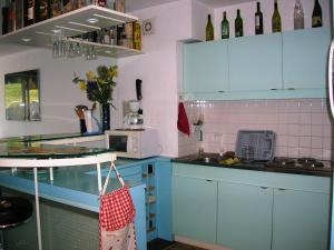 a kitchen with blue cabinets and a sink at Appartement Villard-de-Lans, 2 pièces, 4 personnes - FR-1-689-94 in Villard-de-Lans