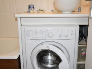 a white washer and dryer under a counter at Studio Villard-de-Lans, 1 pièce, 4 personnes - FR-1-689-91 in Villard-de-Lans