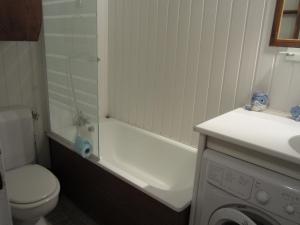 a white bathroom with a toilet and a sink at Studio Villard-de-Lans, 1 pièce, 4 personnes - FR-1-689-91 in Villard-de-Lans