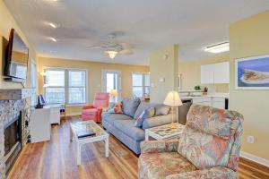 a living room with a blue couch and a fireplace at Park Topsail Beach in Topsail Beach