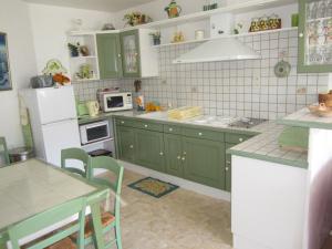 a kitchen with green cabinets and a white refrigerator at Appartement Villard-de-Lans, 3 pièces, 6 personnes - FR-1-689-108 in Villard-de-Lans