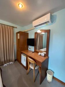 a room with a desk and a mirror at Amorn Mansion in Ao Nang Beach