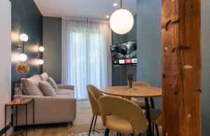a living room with a couch and a table at BIG 4 ROOMS in a Centric Home Parking Included in San Sebastián