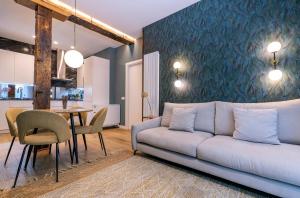 a living room with a couch and a table at BIG 4 ROOMS in a Centric Home Parking Included in San Sebastián