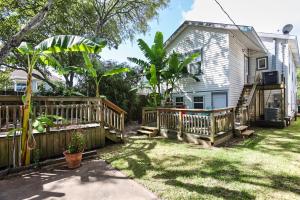 a backyard with a wooden fence and a house at Quick & Intimate Beach Getaway in Galveston