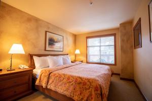 a hotel room with a bed and a window at 3309A - One Bedroom Standard Powderhorn Lodge condo in Solitude